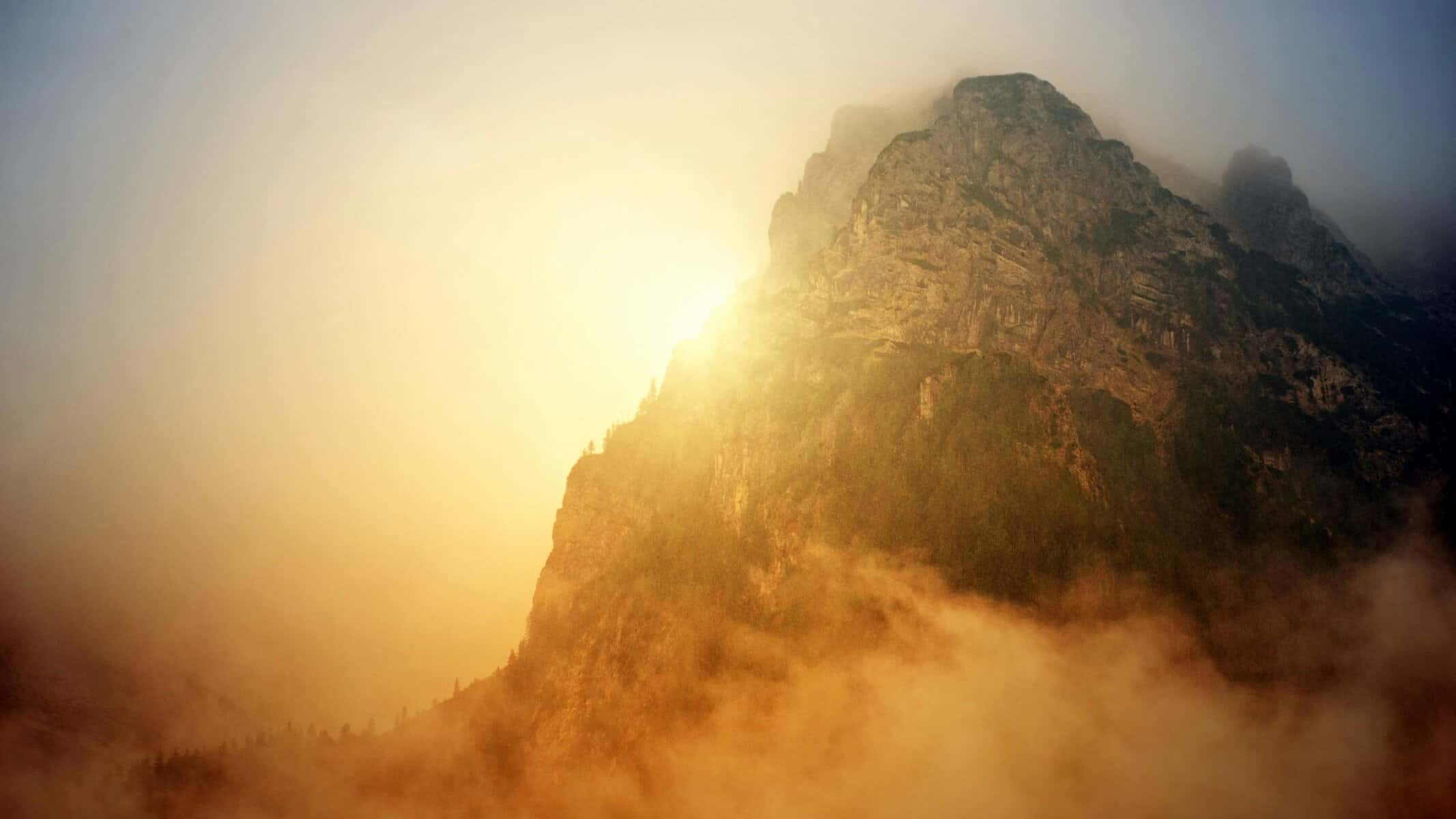 overcoming-fear-with-divine-help-mountain-apollo-light.jpg Mountain peak bathed in golden Apollo light emerging from mist, symbolizing overcoming fear with divine help to climb toward dreams"