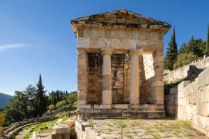 Athenian Treasury at the end of the Sacred Way to divine connection, ancient temple structure at Delphi archaeological site