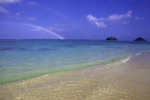 Double rainbow touching down into turquoise paradise waters at Lanikai Beach Hawaii - finding the divine in natural wonder