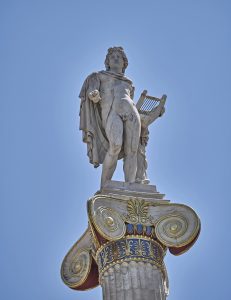 Statue of Apollo with lyre atop Ionic column with blue and gold spirals representing divine inspiration for writers