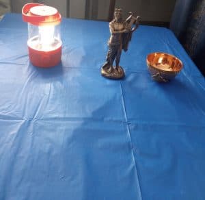 Oracle of Apollo altar with bronze statue, lantern light, and offering bowl representing divine partnership