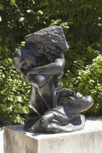Rodin's 'The Caryatid Who Has Fallen Under Her Stone'—a bronze figure struggling beneath crushing weight, representing the sacred burden of becoming an oracle